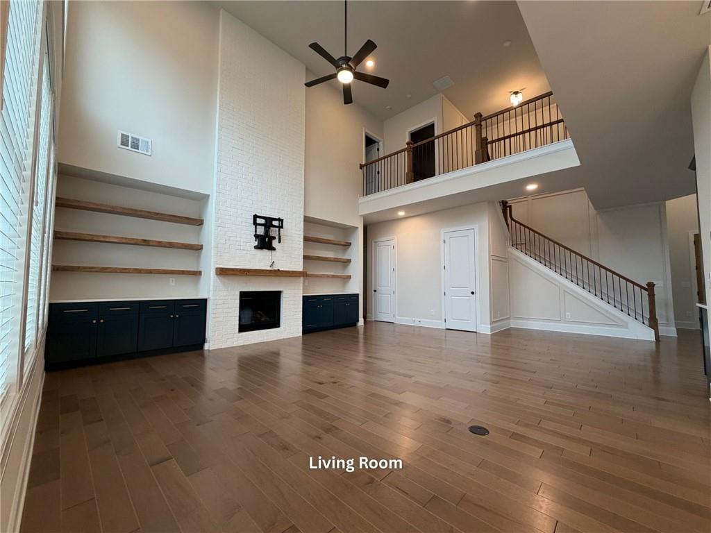 3770 Andover Street Cumming, GA 30028 - Photo 16 of 52 a view of an empty room with a fireplace and a ceiling fan