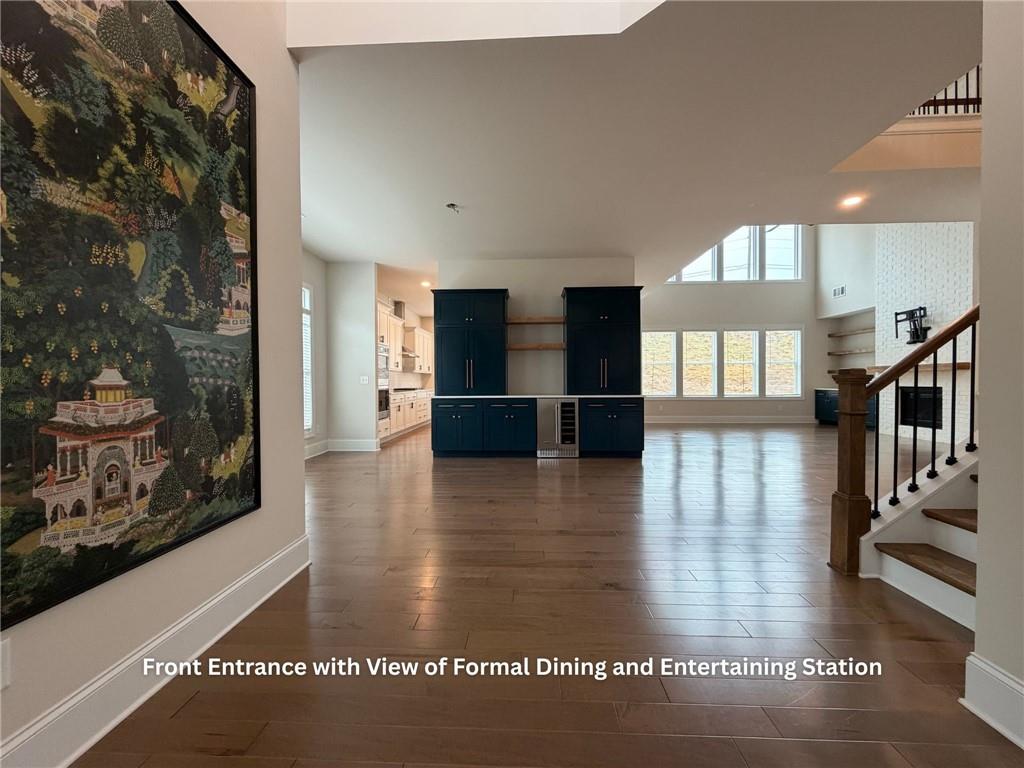 3770 Andover Street Cumming, GA 30028 - Photo 4 of 52 a view of a living room with kitchen view and wooden floor