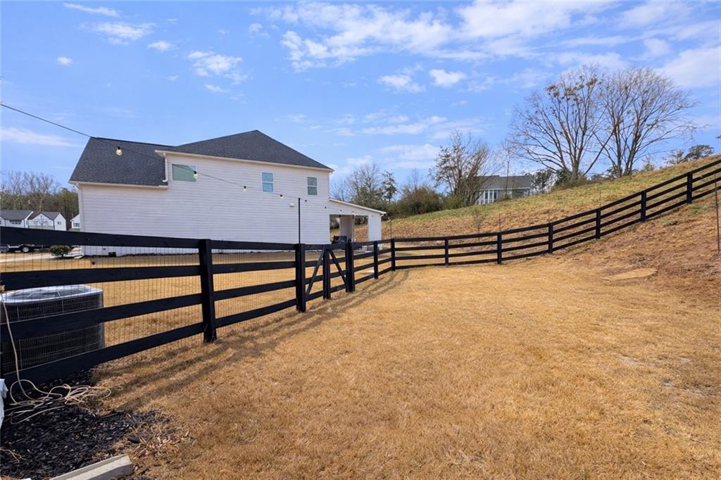 3770 Andover Street Cumming, GA 30028 - Photo 47 of 52 a view of a house with wooden fence and a snow