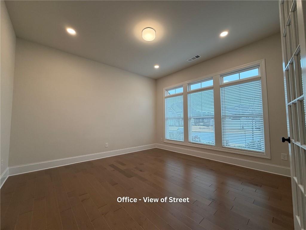 3770 Andover Street Cumming, GA 30028 - Photo 9 of 52 an empty room with wooden floor and windows