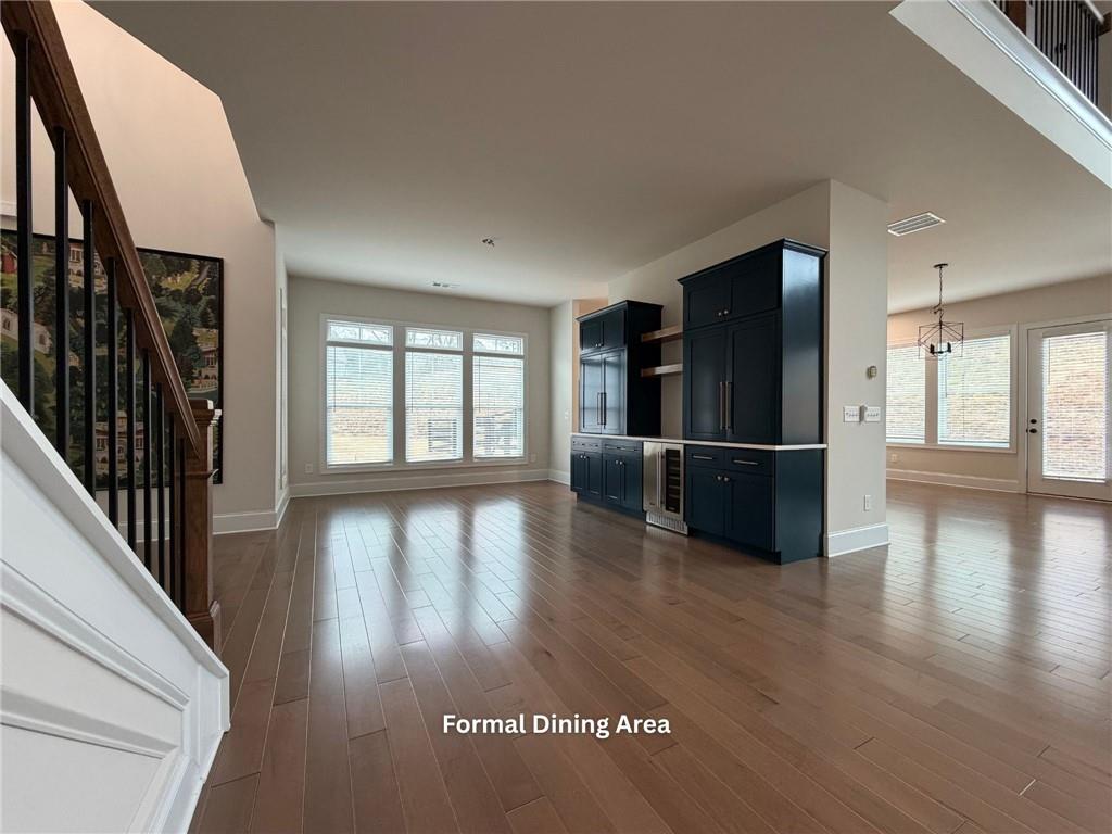 3770 Andover Street Cumming, GA 30028 - Photo 10 of 52 a view of a hallway with wooden floor and a kitchen