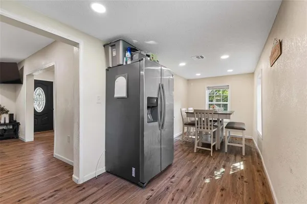 a dining room with furniture and wooden floor
