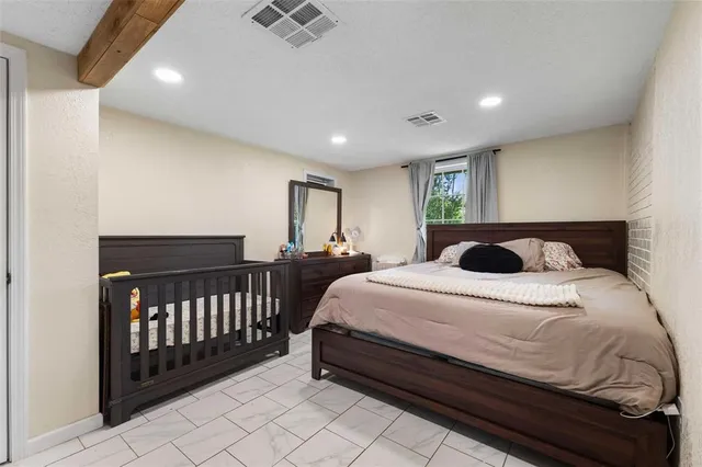 a spacious bedroom with a bed and cabinets