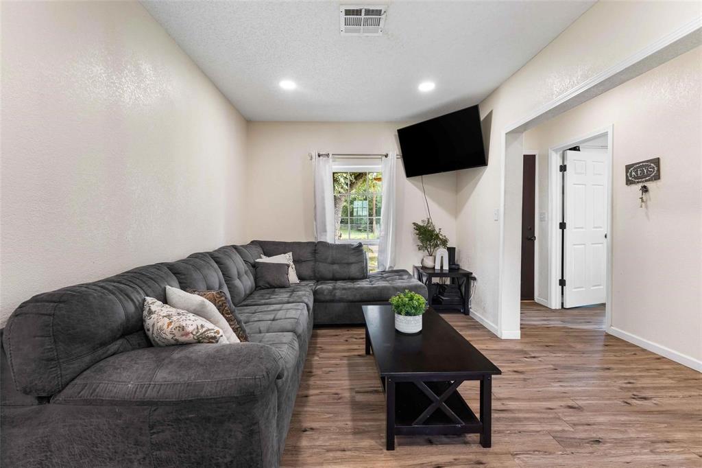 1126 West 7th Street McGregor, TX 76657 - Photo 8 of 33 a living room with furniture flat screen tv and a table