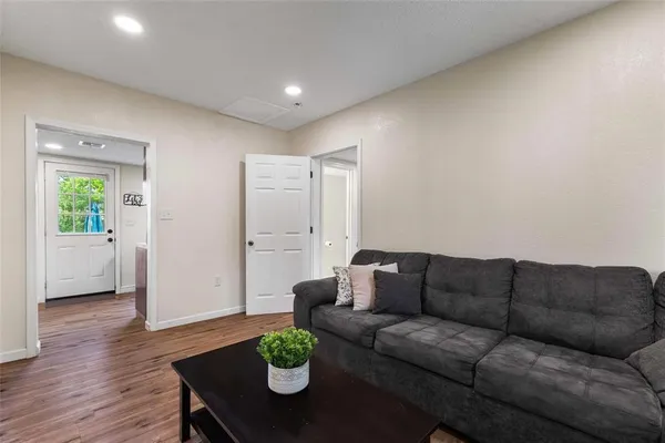 a living room with furniture and wooden floor