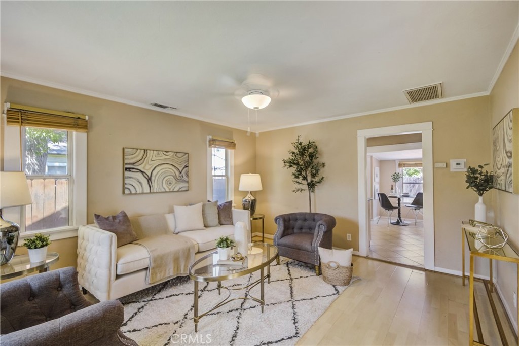a living room with furniture and wooden floor