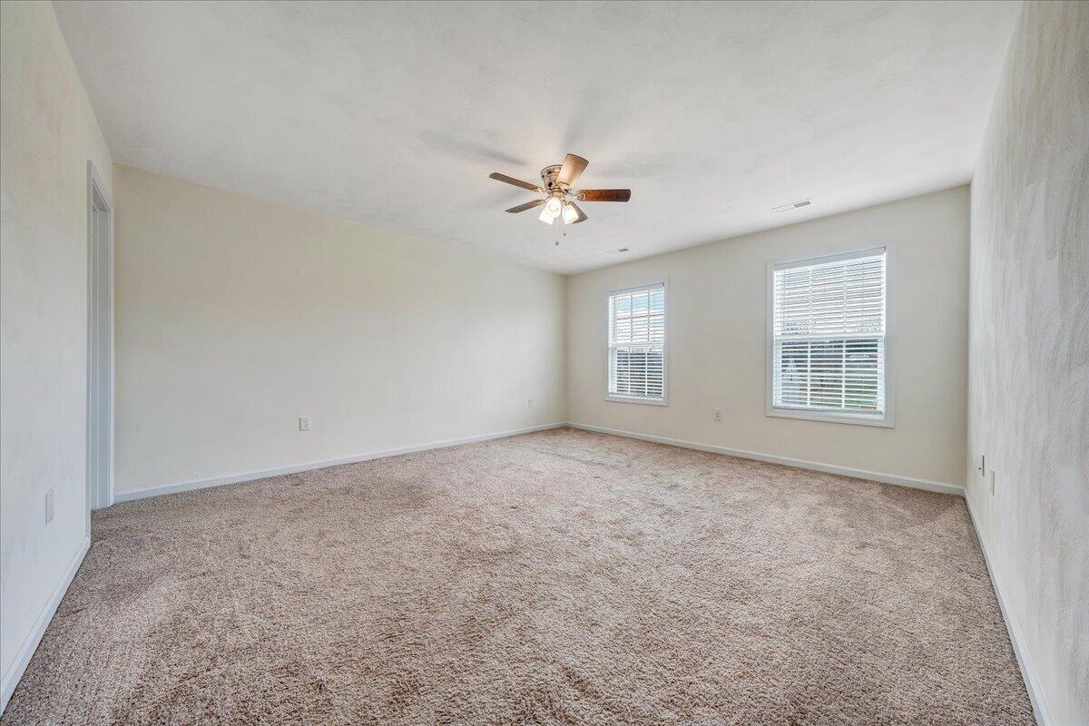 427 Cambridge Ct Road Vinton, VA 24179 - Photo 22 of 46 an empty room with windows and fan