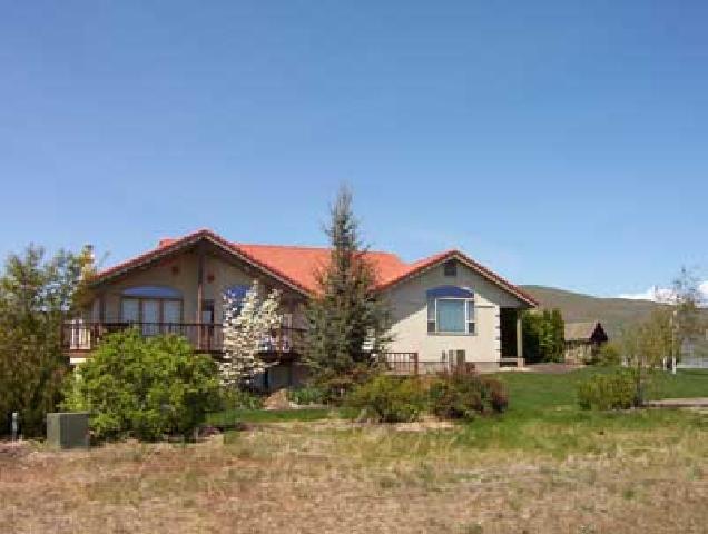 2762 Cook Road Yakima, WA 98908 - Photo 6 of 7 a view of a house with a yard and potted plants
