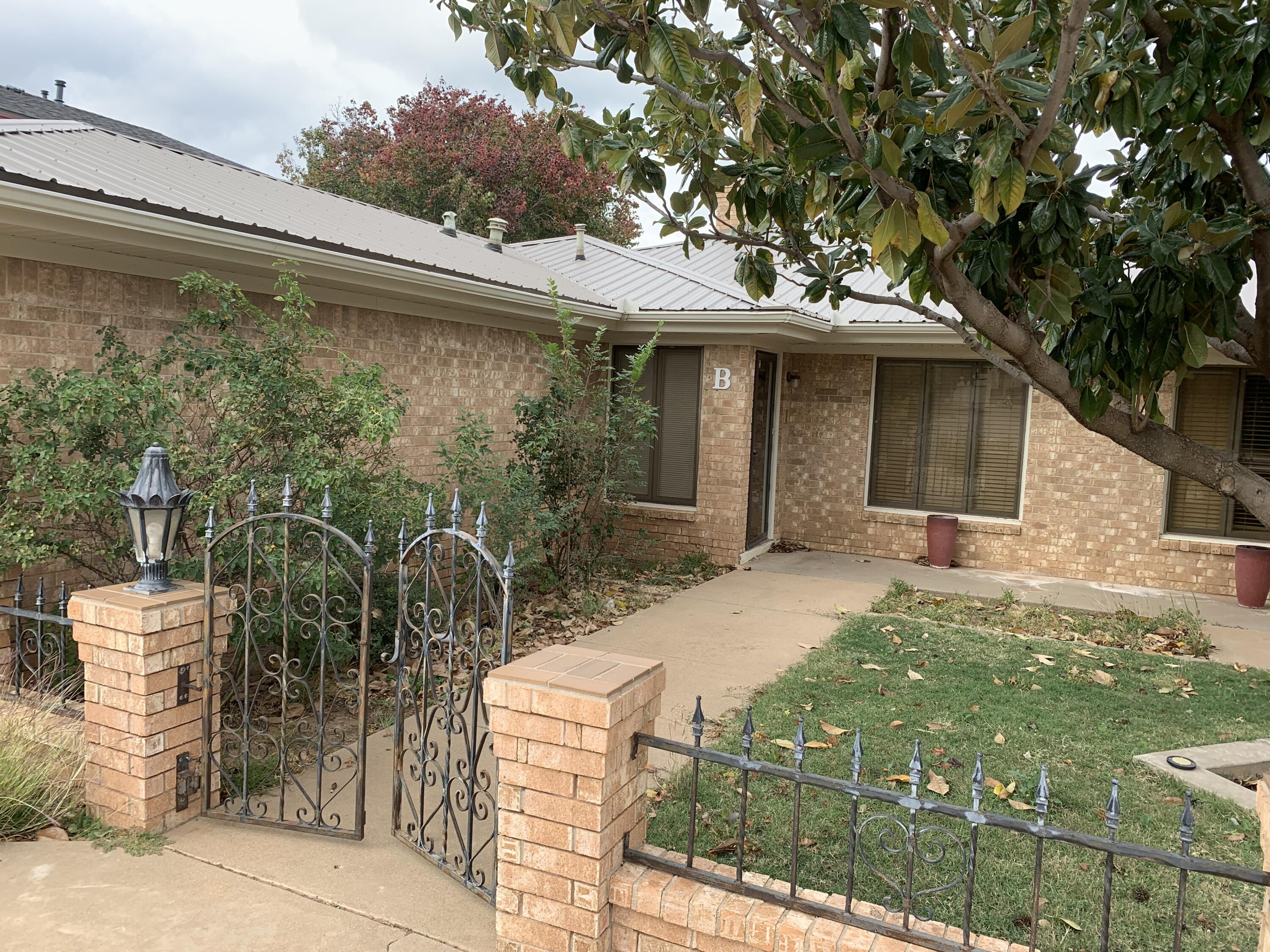 3216 74th Street, Unit B Lubbock, TX 79423 - Photo 3 of 11 a view of a patio with table and chairs and potted plants