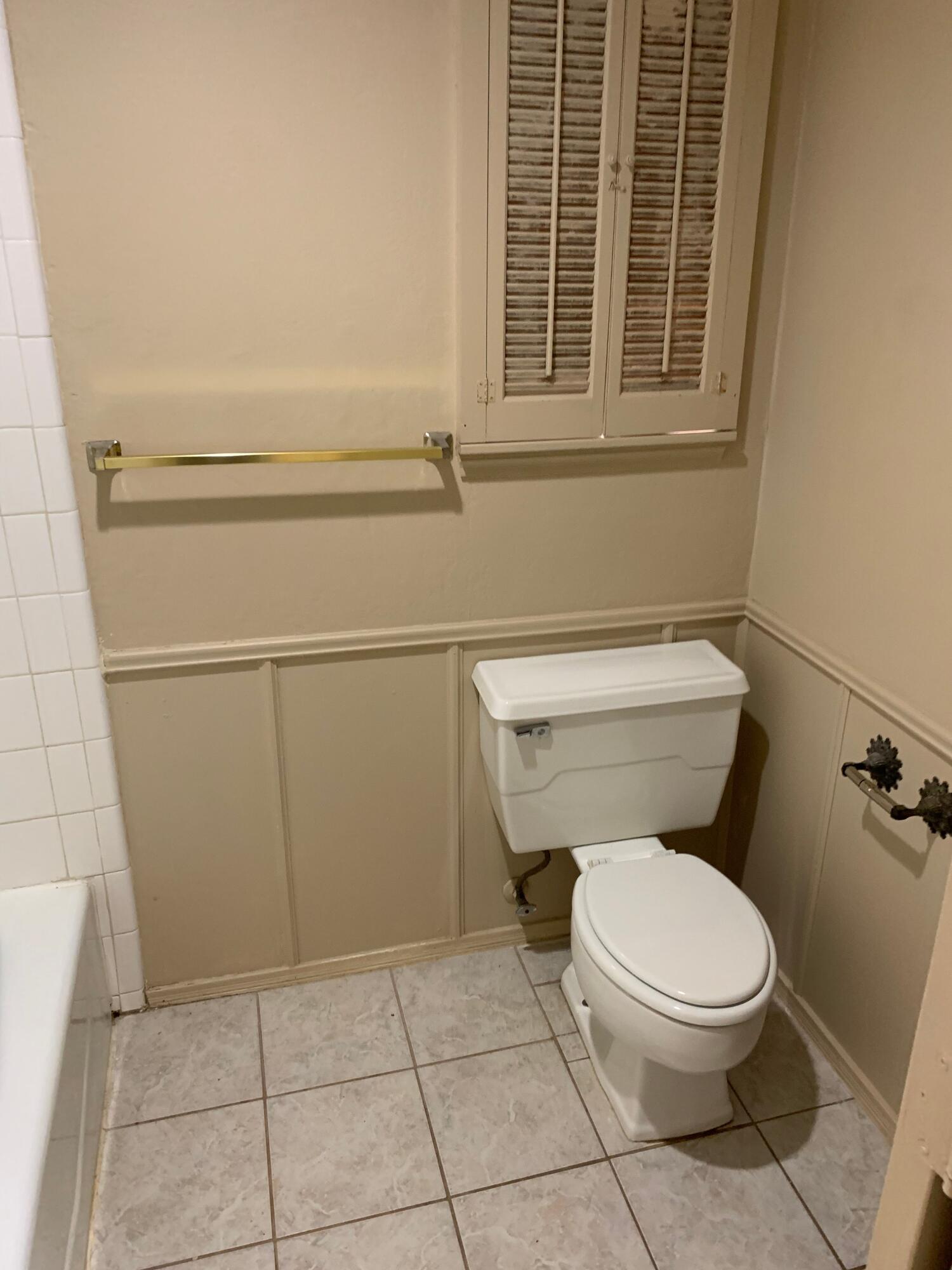 3216 74th Street, Unit B Lubbock, TX 79423 - Photo 6 of 11 a white toilet sitting next to a window