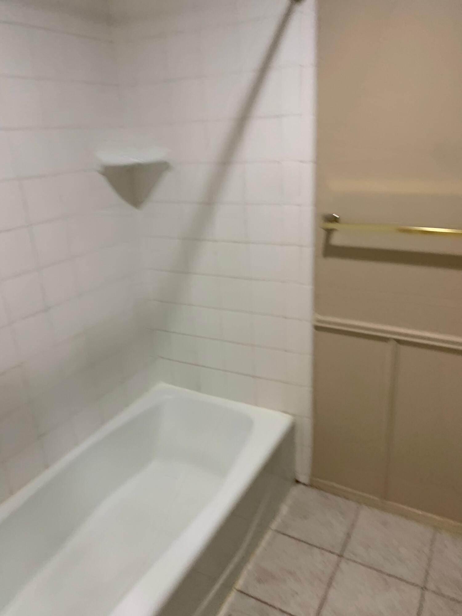 3216 74th Street, Unit B Lubbock, TX 79423 - Photo 7 of 11 a bathroom with a bathtub