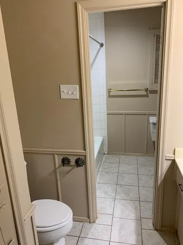 a bathroom with a toilet and a shower