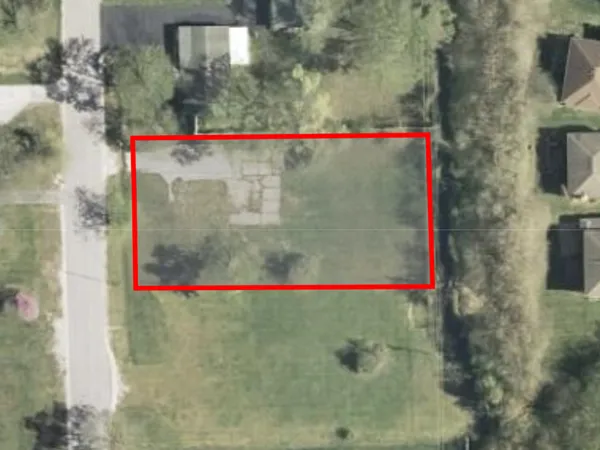 a street sign sitting on a road next to a building