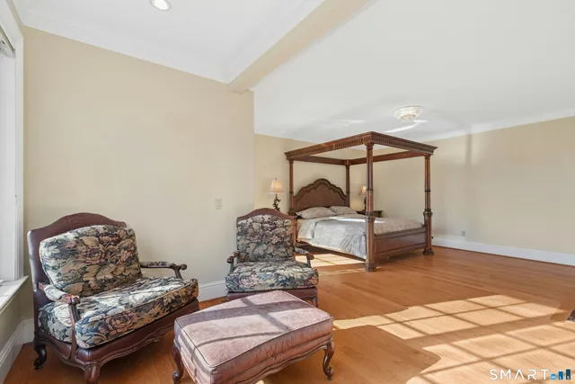 a bedroom with furniture and a window