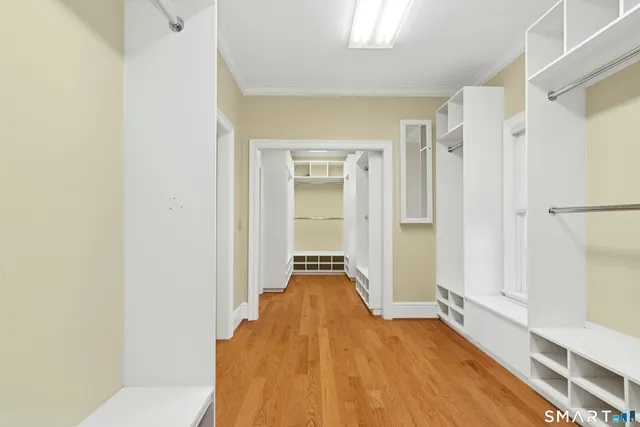 a view of a bedroom with wooden floor and closet