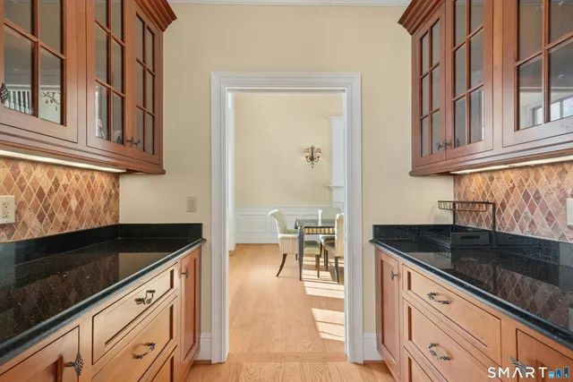 a kitchen with granite countertop a sink and cabinets