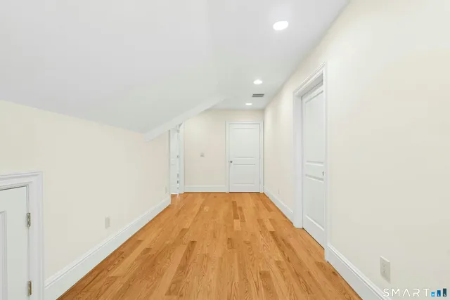 a view of a room with wooden floor