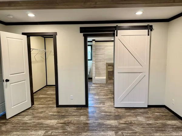 a view of hallway with wooden floor