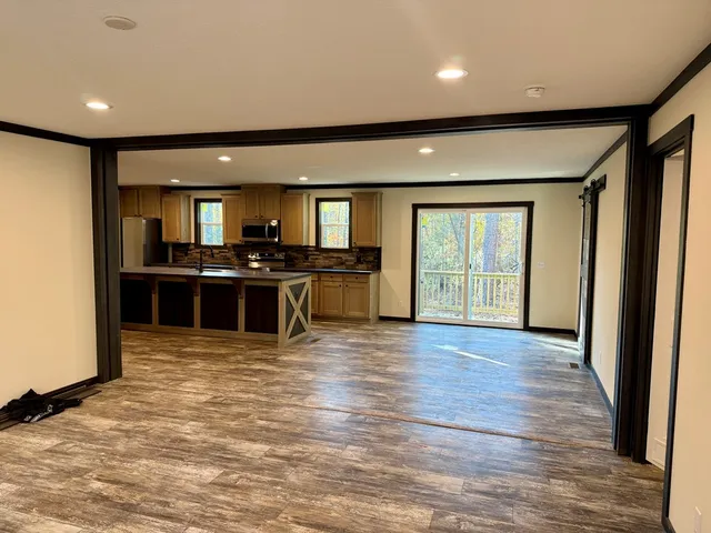 an open kitchen with stainless steel appliances granite countertop a stove and cabinets