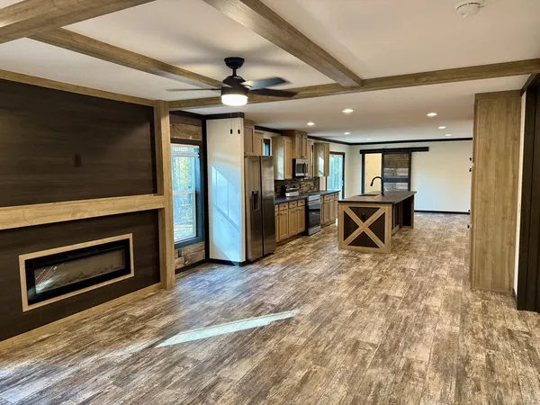 a living room with furniture a fireplace and a ceiling fan