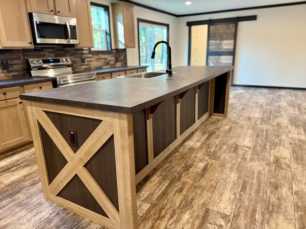 a kitchen with stainless steel appliances granite countertop a sink stove and microwave