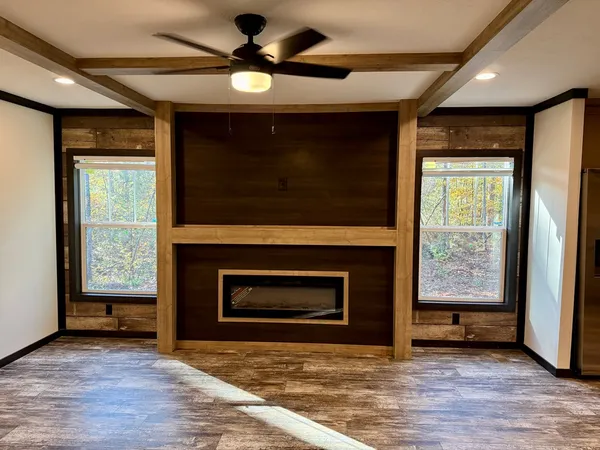 a view of an empty room with a fireplace and a window