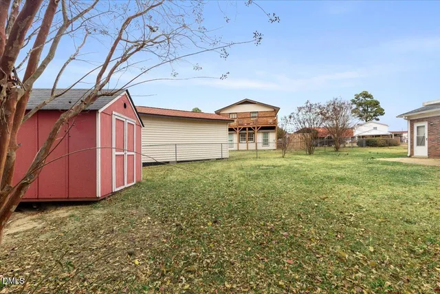 a view of a backyard with a garden and entertaining space