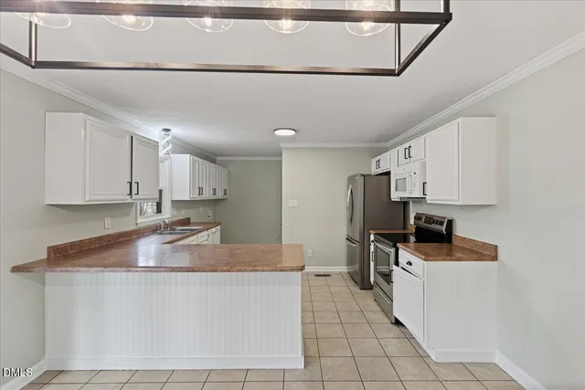 a kitchen with kitchen island granite countertop a sink stove and refrigerator