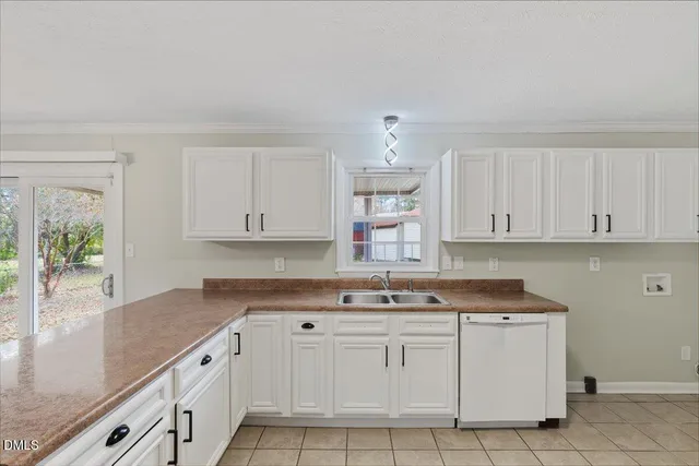 a kitchen with granite countertop white cabinets and white appliances