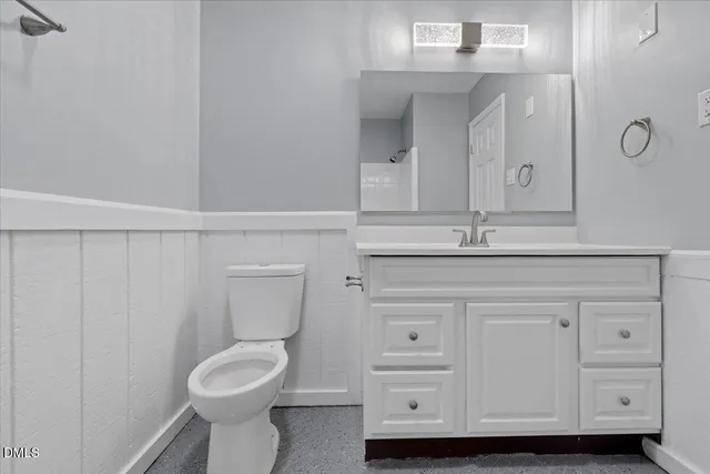 a bathroom with a sink a toilet and mirror