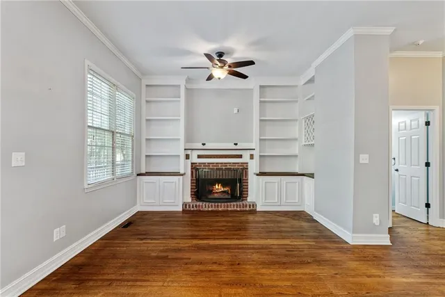 a living room with a fireplace and a walk in closet