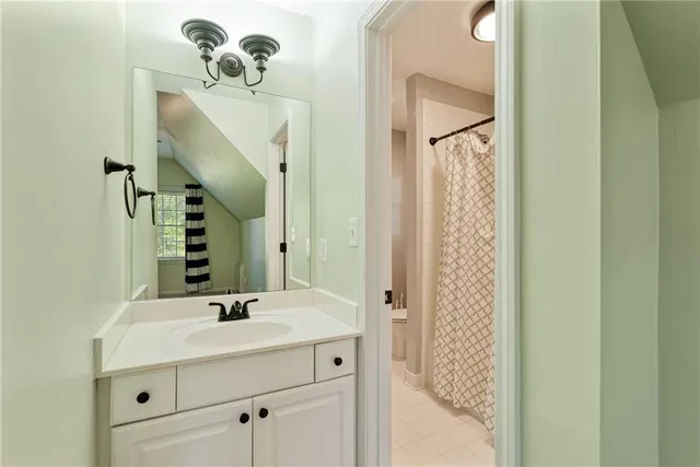 an empty room with ceiling fan and window