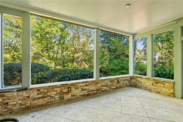 a balcony with wooden floor and fence