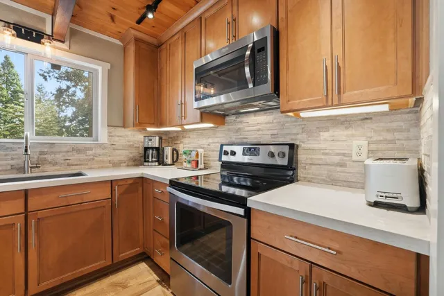 a kitchen with a stove and chairs