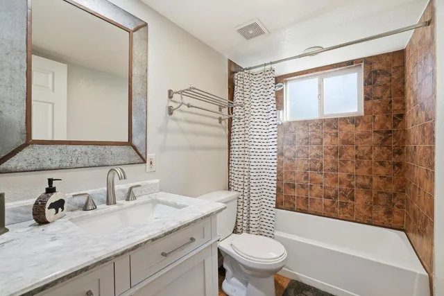 a bedroom with a bed and a mirror