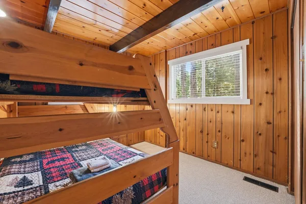 a bed sitting in a room next to a window
