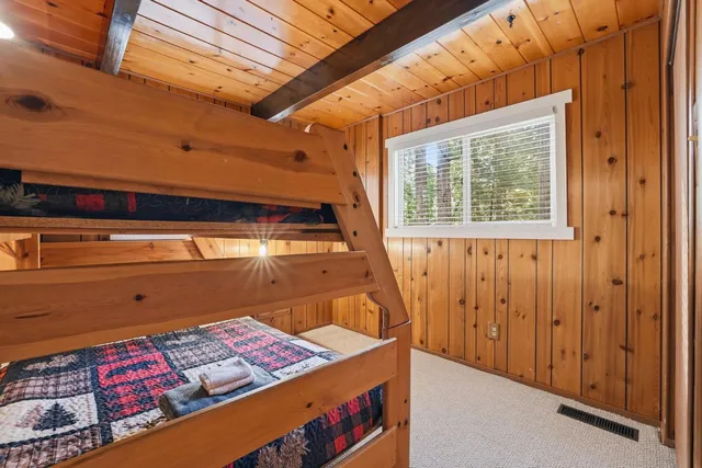 a bed sitting in a room next to a window