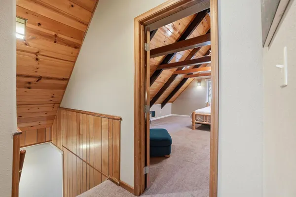 a bathroom with a granite countertop sink a toilet a mirror and shower