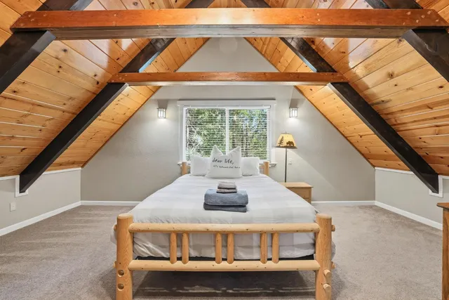a living room with furniture a rug and a flat screen tv