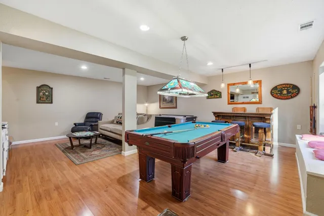 a view of a deck with table and chairs and wooden floor