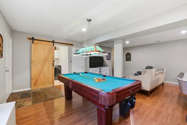a view of a garden with lawn chairs and a large tree