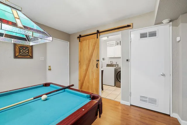a backyard of a house with barbeque oven and wooden fence