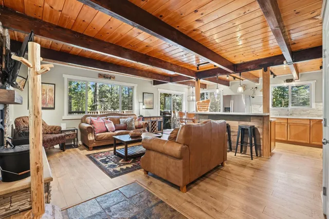 a living room with furniture a fireplace and a table