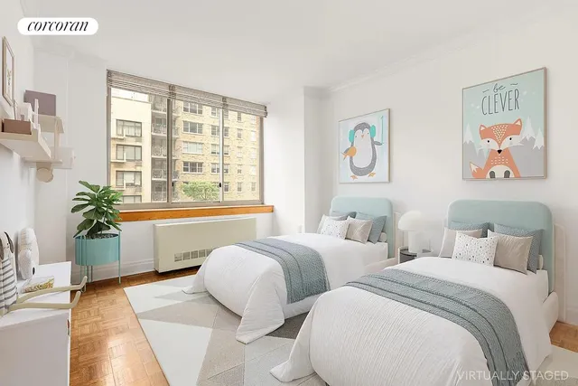 a spacious bedroom with two beds and a large window