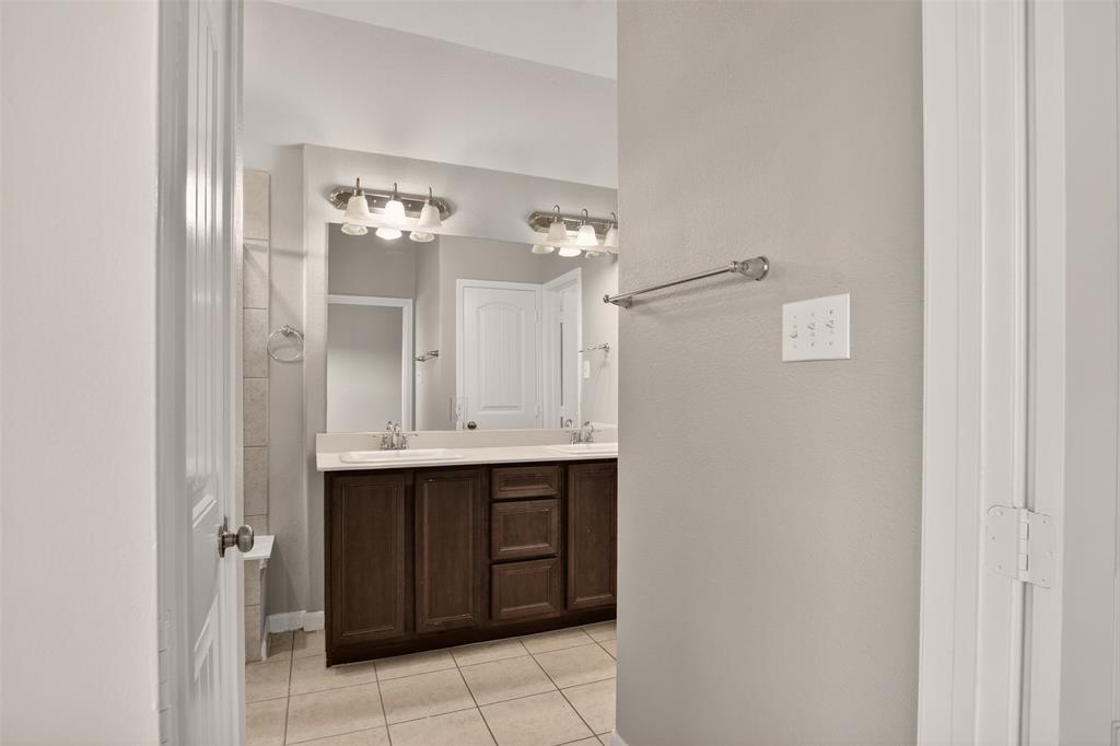 9105 Switchgrass Lane Forney, TX 75126 - Photo 10 of 20 Bathroom featuring a dual vanity with a dark wood-finish cabinet and integrated sinks