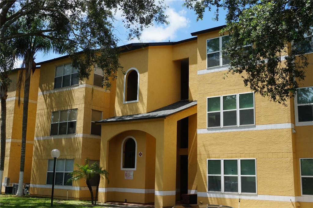 4572 Commander Drive, Unit 1237 Orlando, FL 32822 - Photo 1 of 31 a front view of a house with a tree
