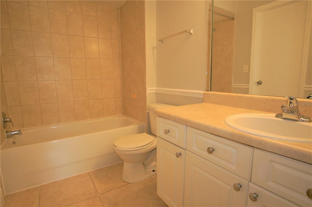4572 Commander Drive, Unit 1237 Orlando, FL 32822 - Photo 11 of 31 a bathroom with a sink a toilet and shower