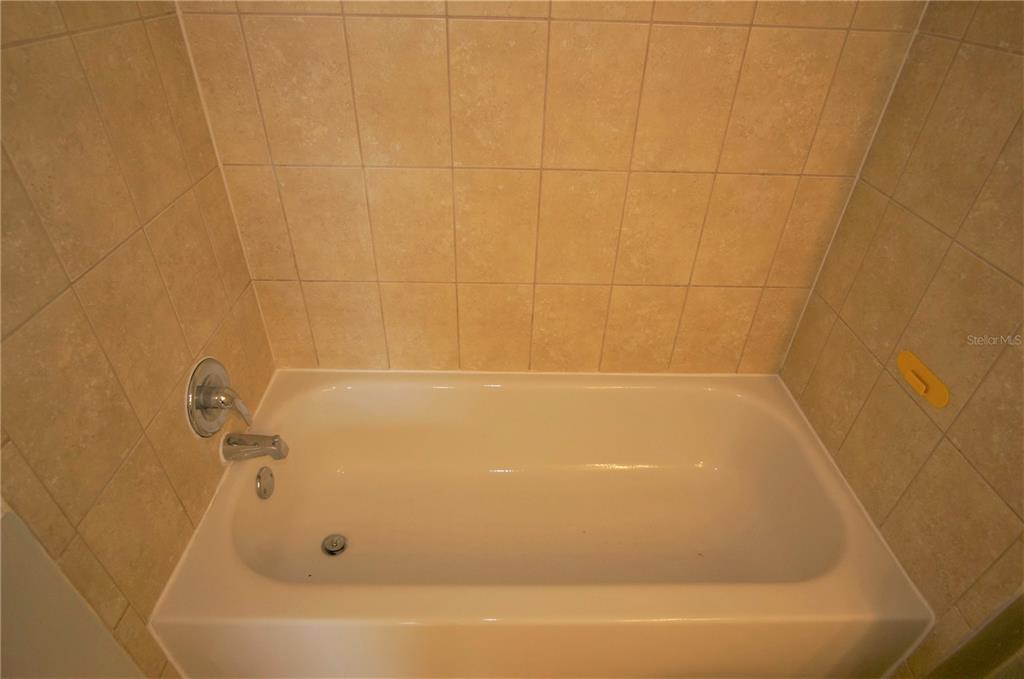 4572 Commander Drive, Unit 1237 Orlando, FL 32822 - Photo 12 of 31 a bathroom with a bathtub