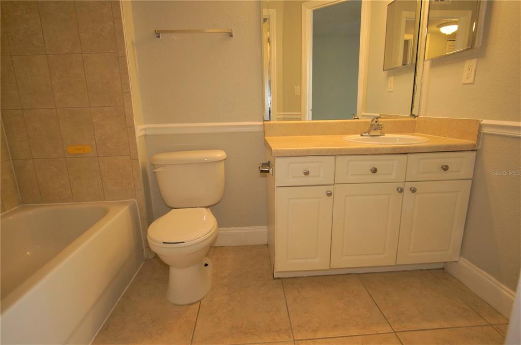 4572 Commander Drive, Unit 1237 Orlando, FL 32822 - Photo 13 of 31 a bathroom with a sink a toilet and bathtub