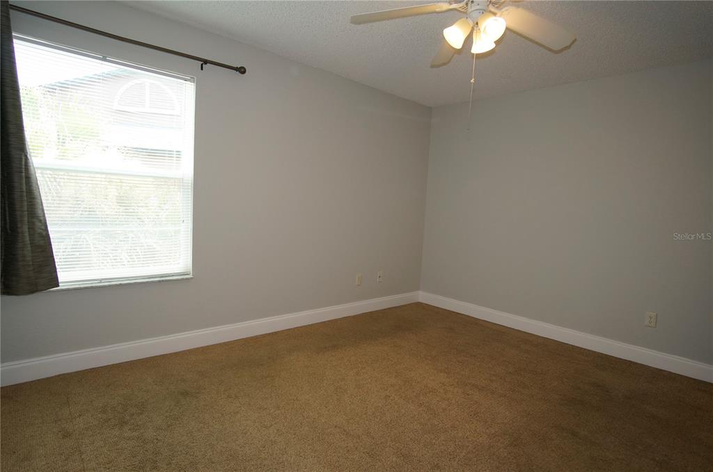 4572 Commander Drive, Unit 1237 Orlando, FL 32822 - Photo 14 of 31 an empty room with a window